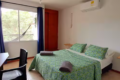 Image showing a comfortable room with a bed whose bedspread is green and is very soft.