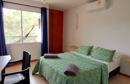 Image showing a comfortable room with a bed whose bedspread is green and is very soft.