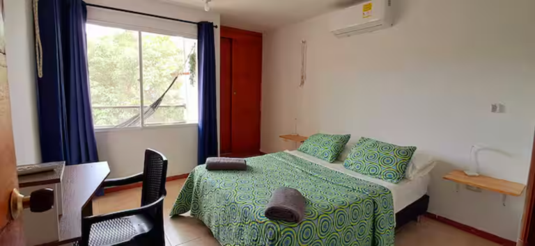 Image showing a comfortable room with a bed whose bedspread is green and is very soft.