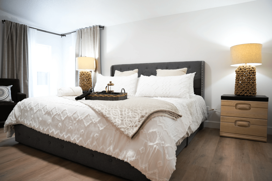 Image showing a room with a comfortable bed with two pillows and a white sheet.